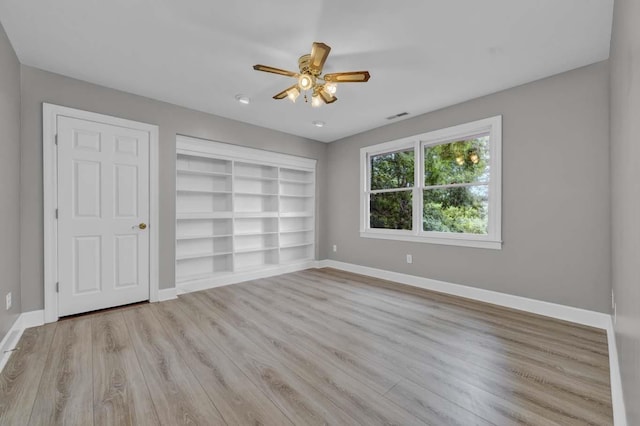 unfurnished bedroom with ceiling fan and light wood-type flooring