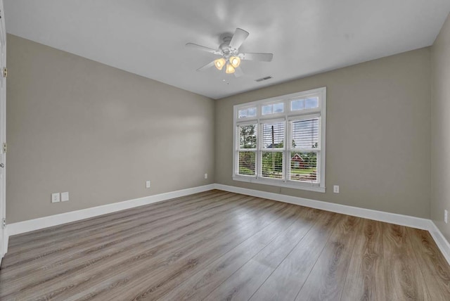 spare room featuring ceiling fan and light hardwood / wood-style floors