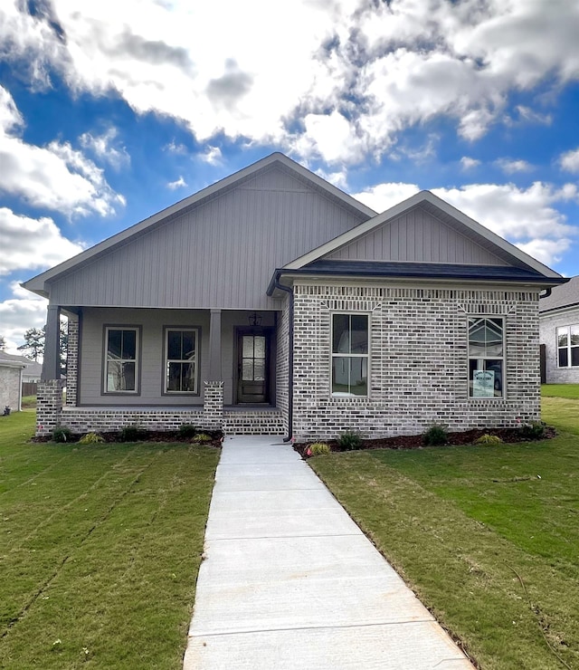 view of front of home with a porch and a front lawn