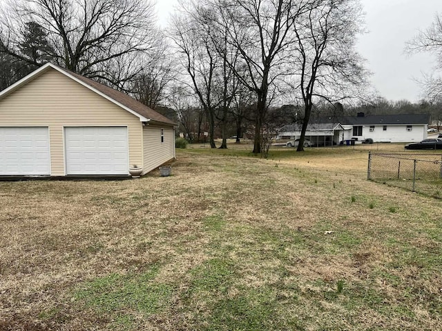 view of yard featuring a garage and an outdoor structure