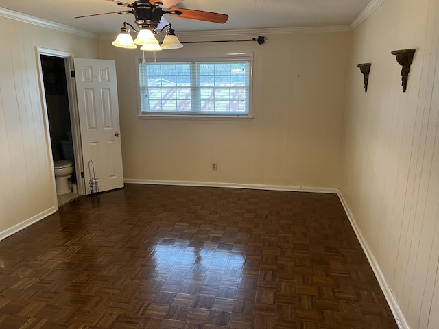 empty room with dark parquet floors, ceiling fan, and ornamental molding