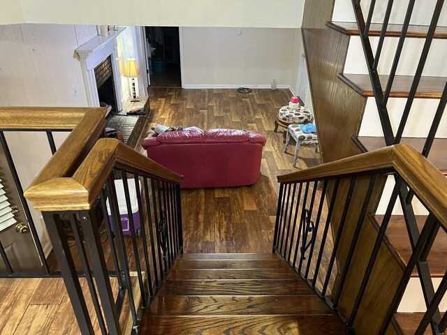 stairway with hardwood / wood-style floors