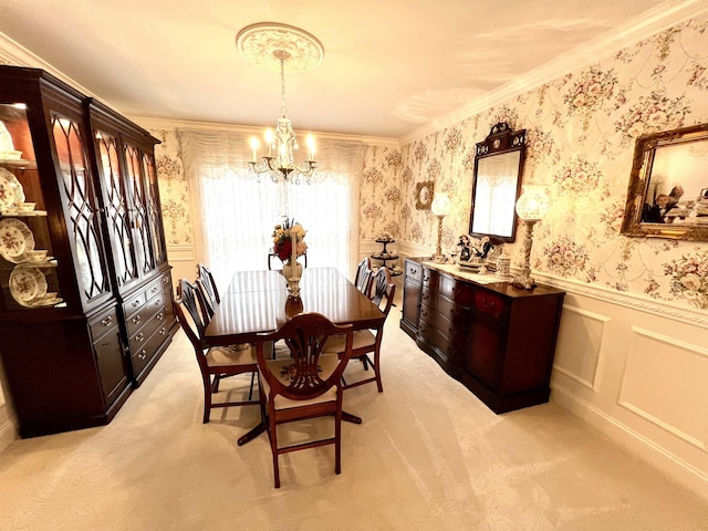 dining area featuring light colored carpet, an inviting chandelier, and ornamental molding