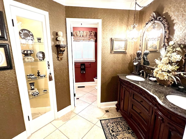 bathroom with tile patterned flooring, vanity, ornamental molding, and toilet