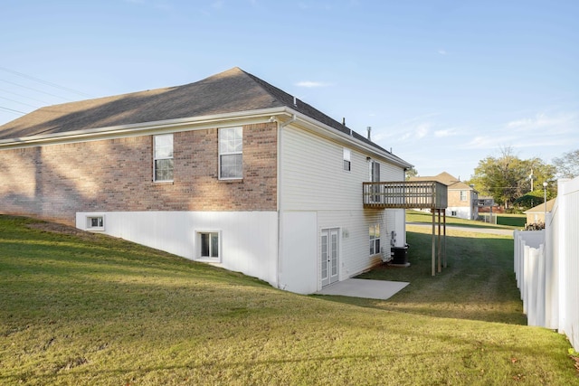 view of home's exterior featuring a deck, central air condition unit, and a lawn