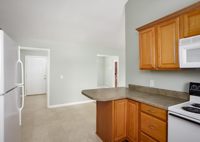 kitchen featuring white appliances and kitchen peninsula