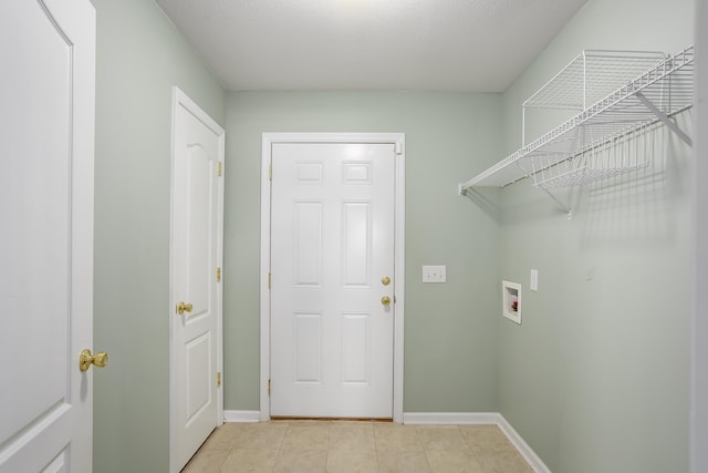 clothes washing area featuring washer hookup and light tile patterned flooring