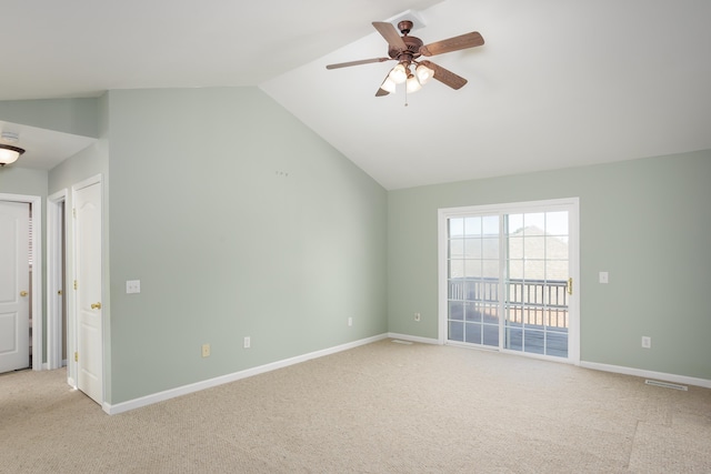 interior space with ceiling fan, light colored carpet, and lofted ceiling