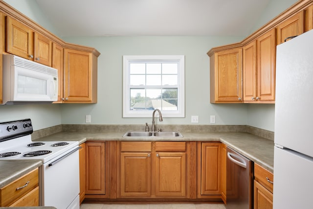 kitchen featuring white appliances and sink