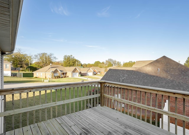 wooden terrace featuring a lawn