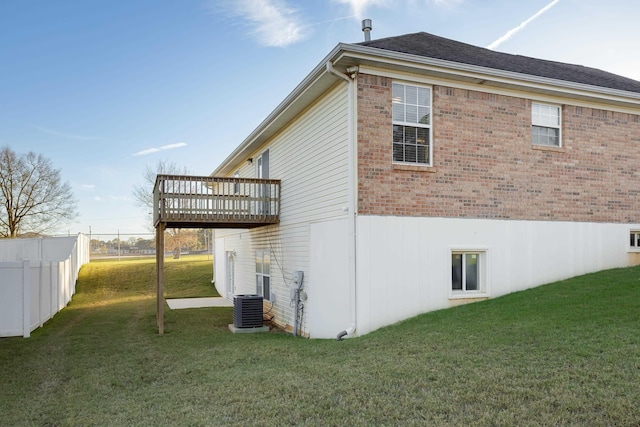 view of home's exterior with a lawn, a wooden deck, and cooling unit