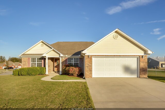 ranch-style house with a garage and a front yard