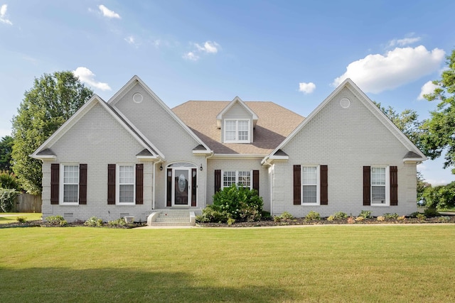  - view of front of property with brick siding and a front yard
