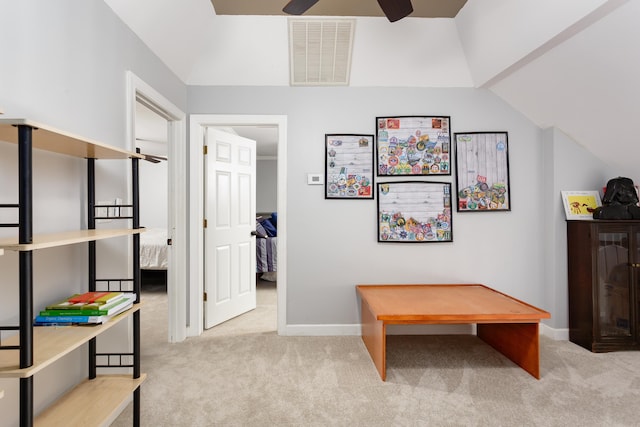 interior space featuring lofted ceiling, visible vents, and carpet flooring