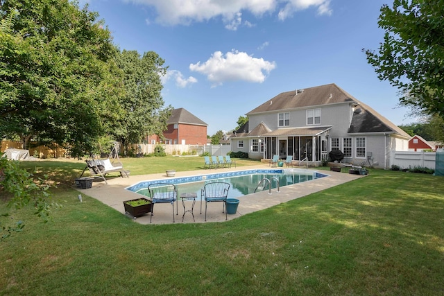 view of swimming pool with a fenced in pool, a yard, a sunroom, a patio area, and a fenced backyard