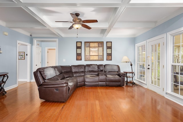 living room with light wood-style floors, coffered ceiling, beamed ceiling, and baseboards