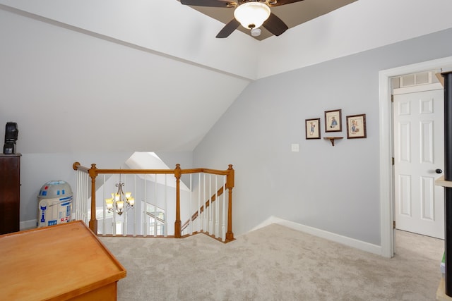 bonus room featuring lofted ceiling, ceiling fan with notable chandelier, visible vents, baseboards, and carpet