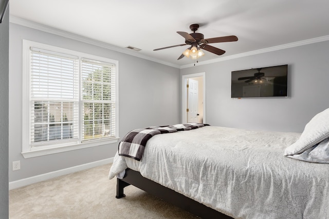 bedroom featuring carpet flooring, a ceiling fan, visible vents, baseboards, and ornamental molding