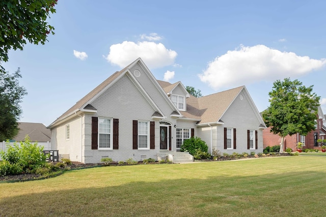 view of front of property featuring brick siding and a front lawn