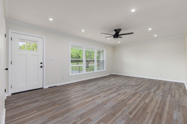 entrance foyer featuring ornamental molding, plenty of natural light, and wood finished floors