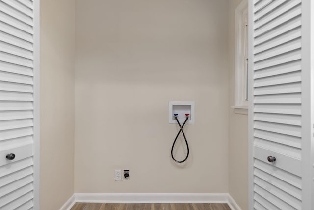 laundry room with washer hookup, laundry area, electric dryer hookup, wood finished floors, and baseboards