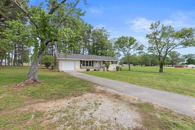 ranch-style house with covered porch, driveway, a front yard, and a garage