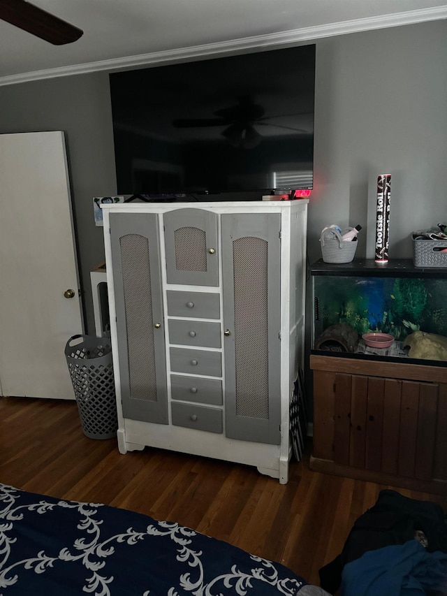 bedroom with ornamental molding and dark hardwood / wood-style flooring