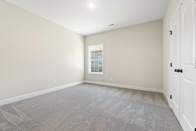 unfurnished bedroom featuring carpet floors and a closet