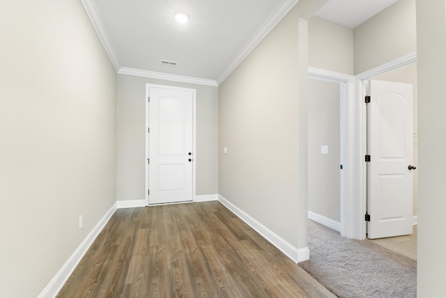 corridor featuring ornamental molding and hardwood / wood-style floors