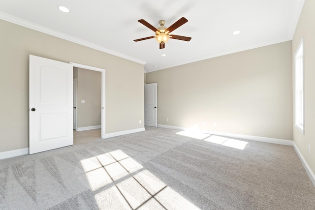 unfurnished bedroom featuring ornamental molding, light carpet, and ceiling fan