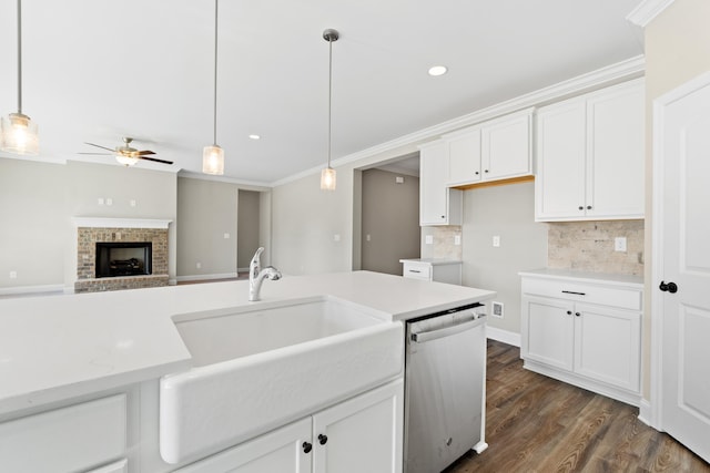 kitchen featuring sink, white cabinetry, dishwasher, pendant lighting, and decorative backsplash