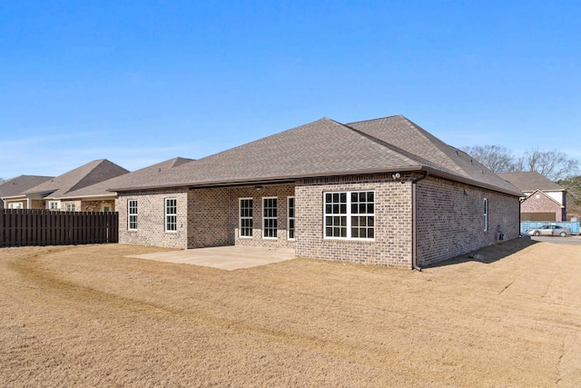 back of house with a yard and a patio