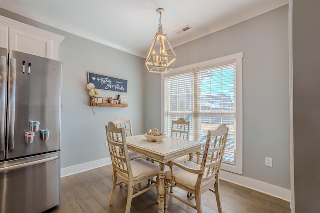 dining area with dark wood-style floors, baseboards, visible vents, and a chandelier