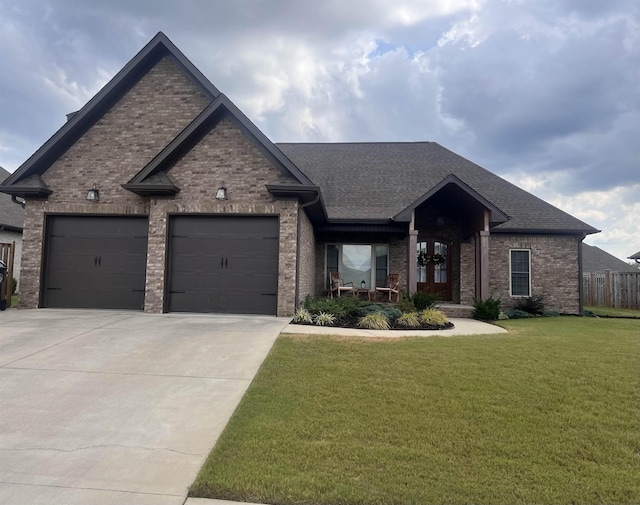 view of front of house featuring an attached garage, a front lawn, and brick siding