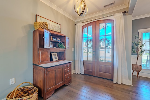 entryway with dark wood-type flooring, french doors, visible vents, and crown molding