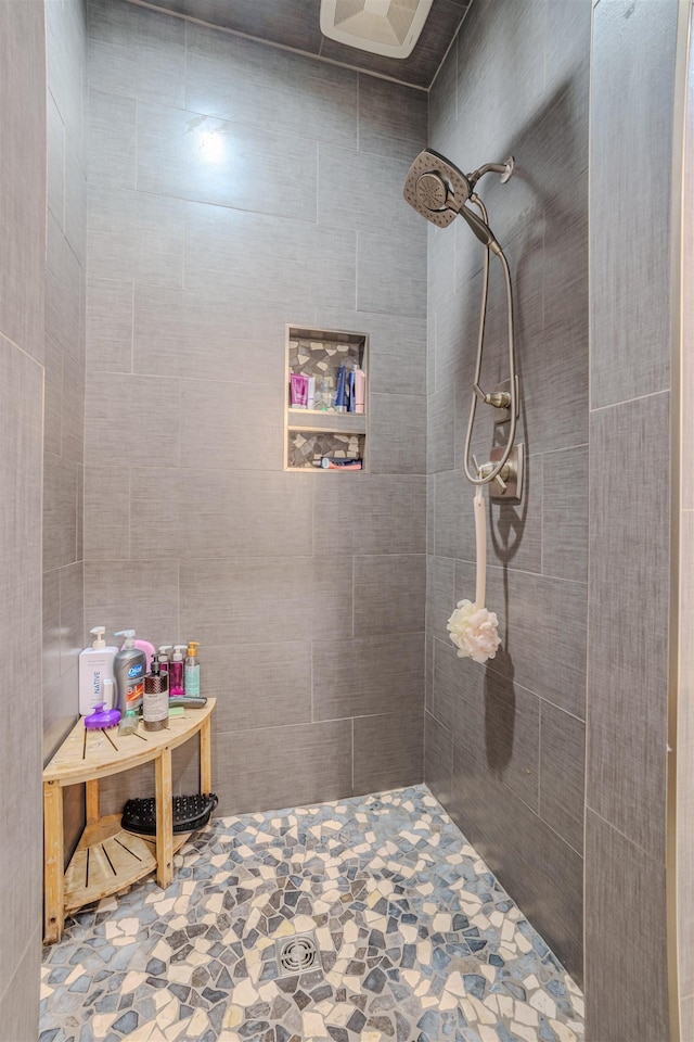 full bath with a tile shower