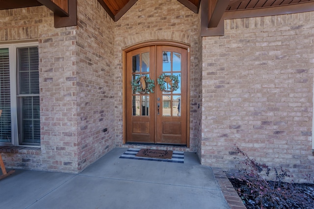 entrance to property with french doors and brick siding