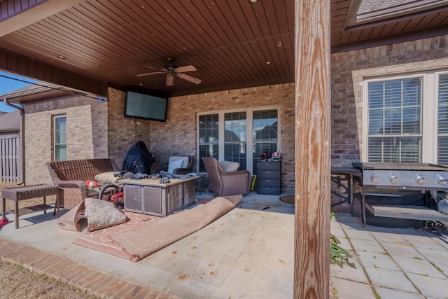 view of patio with a fire pit and a ceiling fan