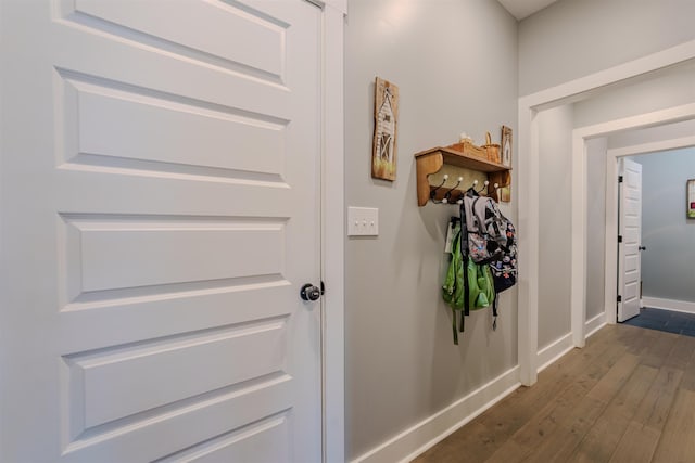 hall featuring dark wood finished floors and baseboards