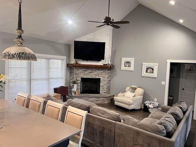 living room with dark wood-type flooring, a fireplace, high vaulted ceiling, and ceiling fan