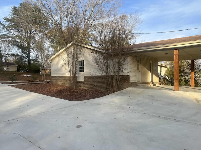 view of side of property featuring a carport