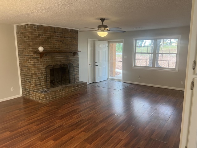 unfurnished living room with a fireplace, a textured ceiling, dark hardwood / wood-style flooring, and ceiling fan