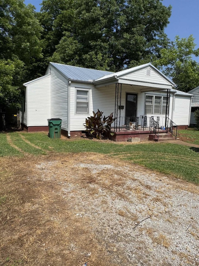  - view of front of house featuring covered porch, metal roof, and crawl space