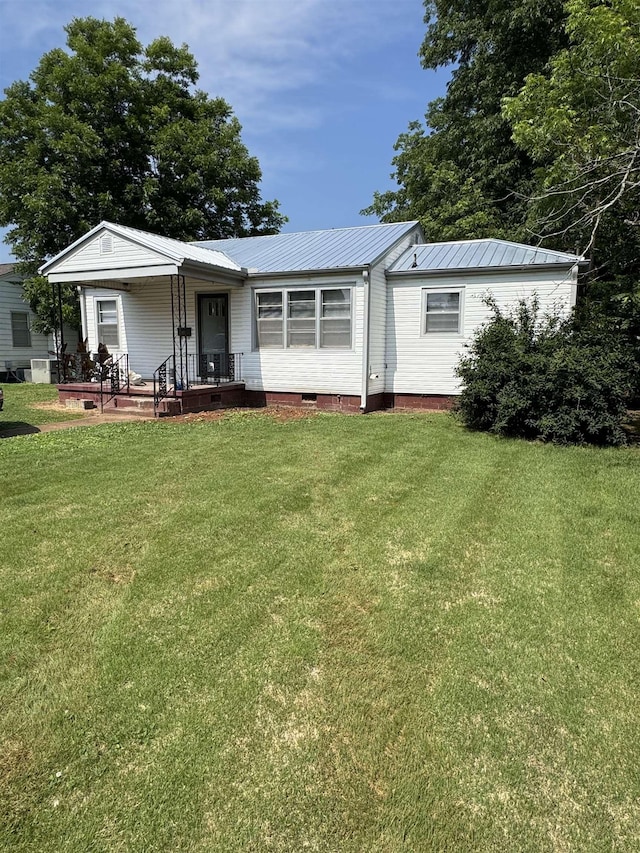 - view of front facade with a front lawn, metal roof, and crawl space