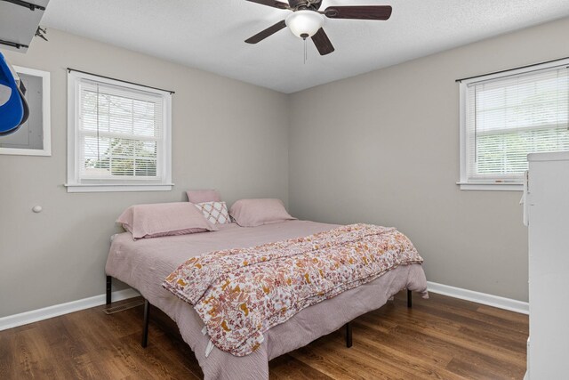  - bedroom with multiple windows, wood finished floors, and ceiling fan
