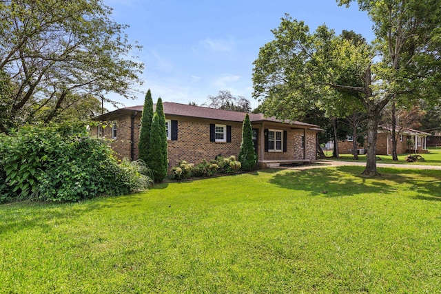  - single story home featuring brick siding and a front yard