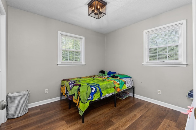  - bedroom with wood finished floors and baseboards