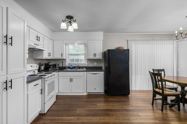  - kitchen with white appliances, a chandelier, and dark countertops