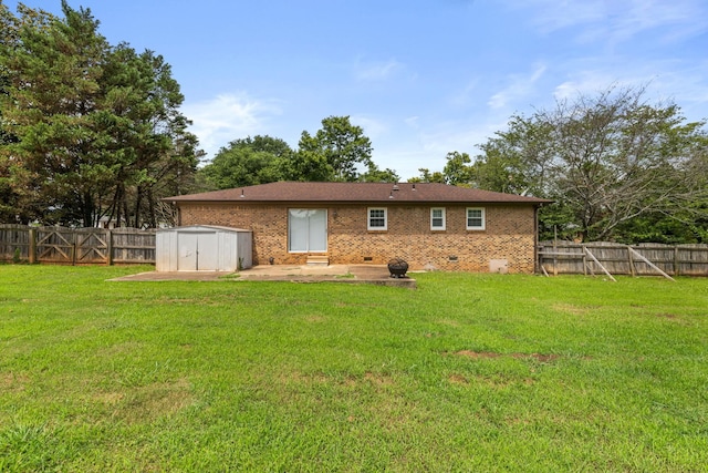  - back of property with a fenced backyard, a patio, a storage shed, and brick siding