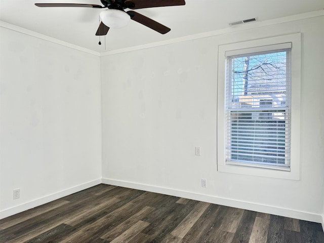 spare room with ornamental molding, dark wood-type flooring, and ceiling fan